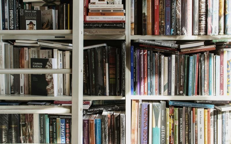 a large collection of books on shelves at a pet friendly apartment in Dayton Ohio