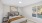 Bedroom with art, cozy bed, and side table