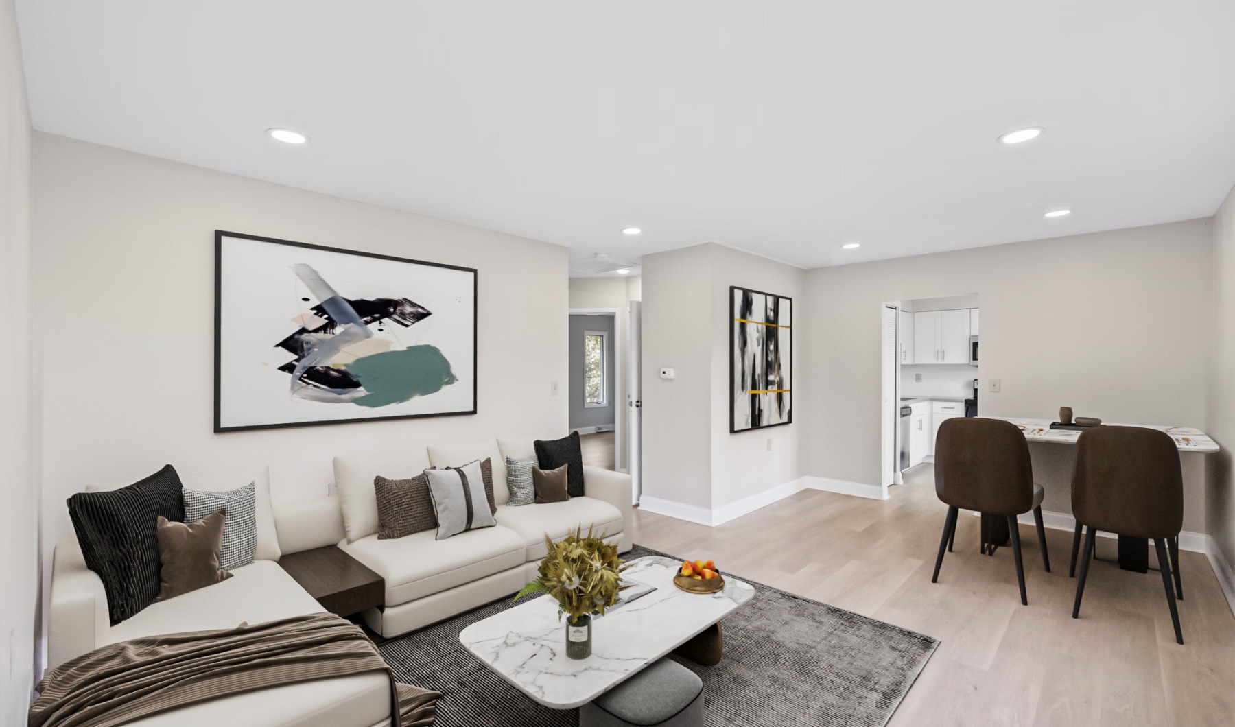 Living Room at Pleasantwood Apartments and Townhomes Furnished living room with art and rug