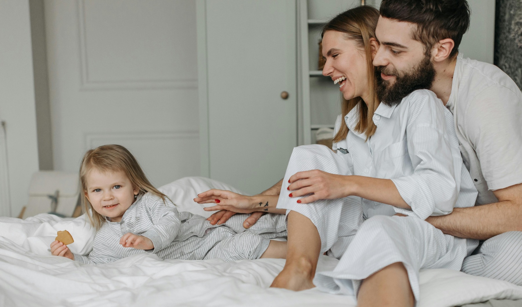 Smart Living at Pleasantwood Apartments Family on bed at Pleasantwood Apartments