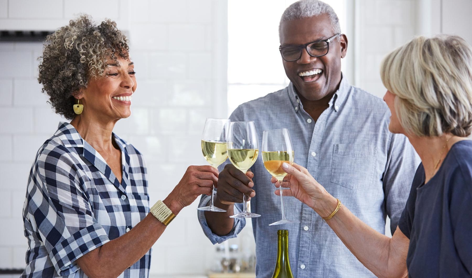 a few people toasting wine glasses at Pleasantwood Senior Apartments & Townhomes